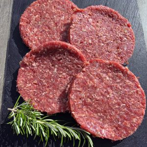 4 beef burgers on a slate platter