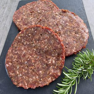 3 caramelised onion steak burgers on a slate platter