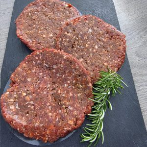 3 dirty brisket burgers on a slate platter