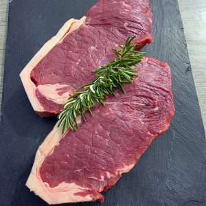 2 sirloin steaks on a slate platter